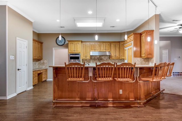 2176 English Rd, Rockwall, TX 75032 - kitchen featuring double oven, backsplash, under cabinet range hood, dark wood-type flooring, and visible vents
