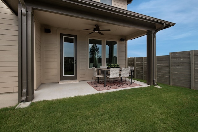 view of yard with fence, a ceiling fan, and a patio