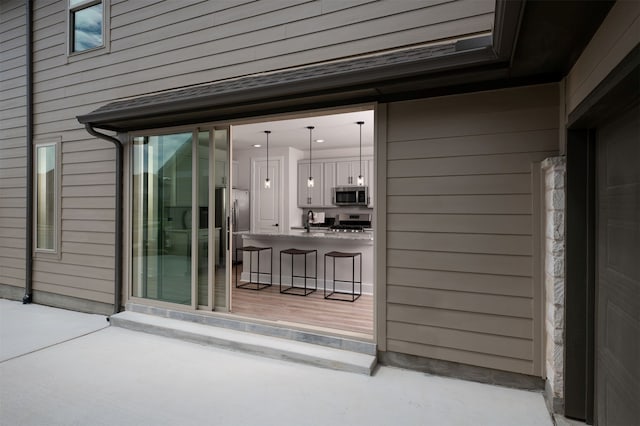view of patio with outdoor dry bar and a sink