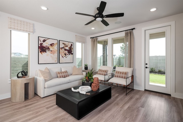 living room with recessed lighting, a ceiling fan, light wood-style flooring, and baseboards