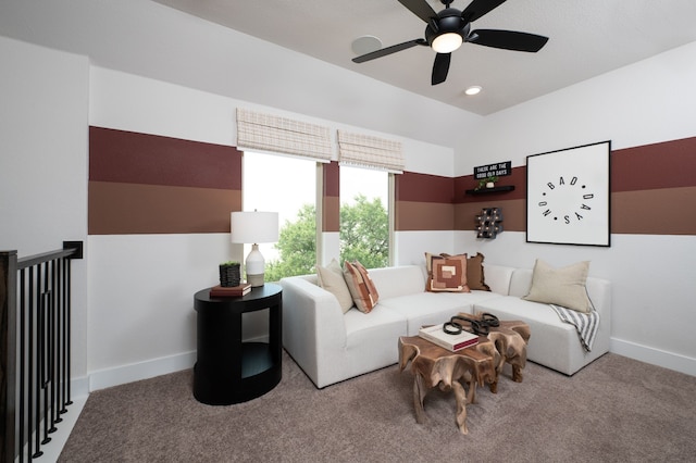living room featuring ceiling fan, baseboards, and carpet floors