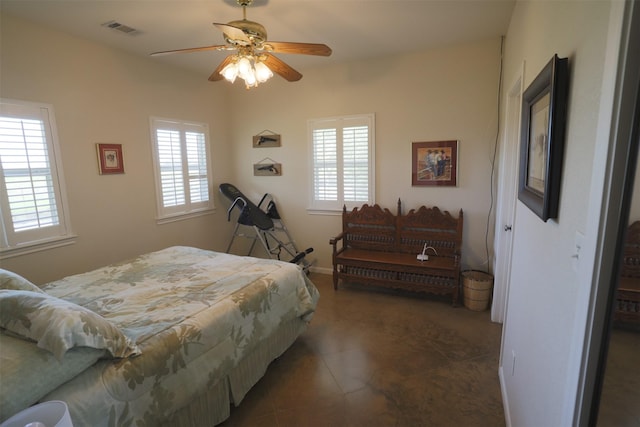 tiled bedroom with visible vents, a ceiling fan, and multiple windows