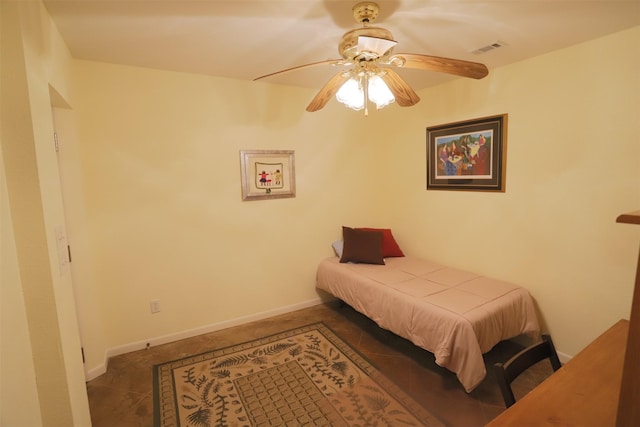 tiled bedroom with visible vents, a ceiling fan, and baseboards