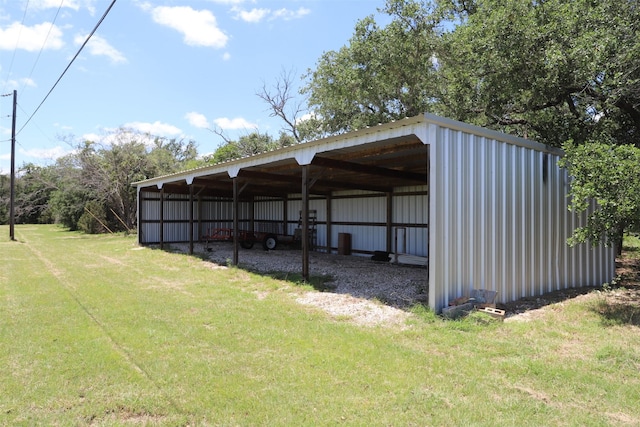 view of pole building with a lawn and a carport