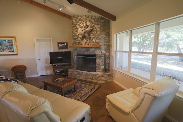 living area with vaulted ceiling with beams, baseboards, a fireplace, and track lighting