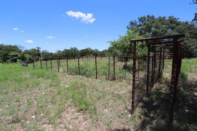 view of yard with a rural view and fence