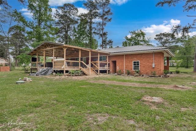1042 N Lane Dr, Shreveport, LA 71107 - back of house with a lawn, a deck, brick siding, and metal roof