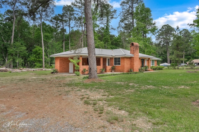 1042 N Lane Dr, Shreveport, LA 71107 - ranch-style house featuring driveway, a chimney, a front yard, and metal roof
