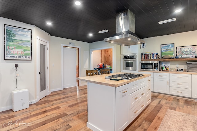 1042 N Lane Dr, Shreveport, LA 71107 - kitchen featuring white cabinets, wooden counters, exhaust hood, stainless steel appliances, and light wood-style floors