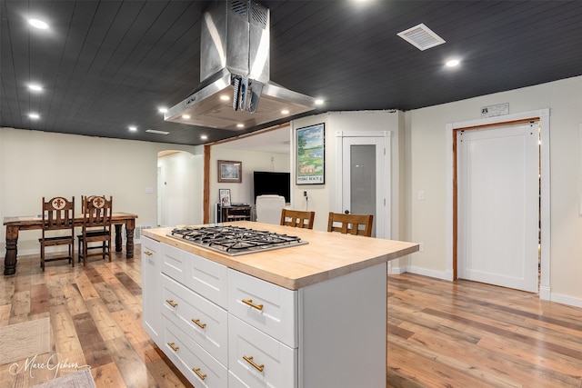 1042 N Lane Dr, Shreveport, LA 71107 - kitchen with arched walkways, visible vents, light wood-style floors, island range hood, and stainless steel gas stovetop