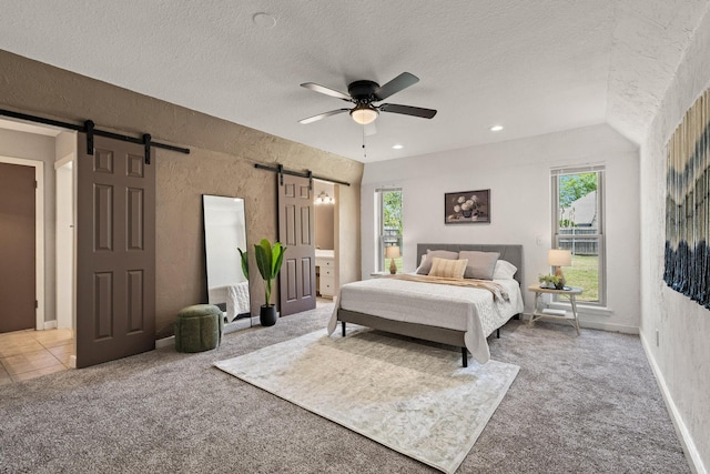 carpeted bedroom with multiple windows, a textured ceiling, recessed lighting, and a barn door