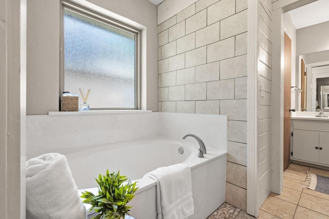 full bathroom with a bath, vanity, and tile patterned flooring