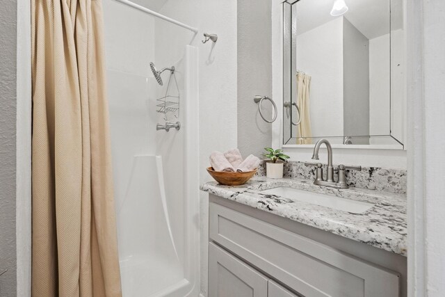 bathroom with vanity and curtained shower