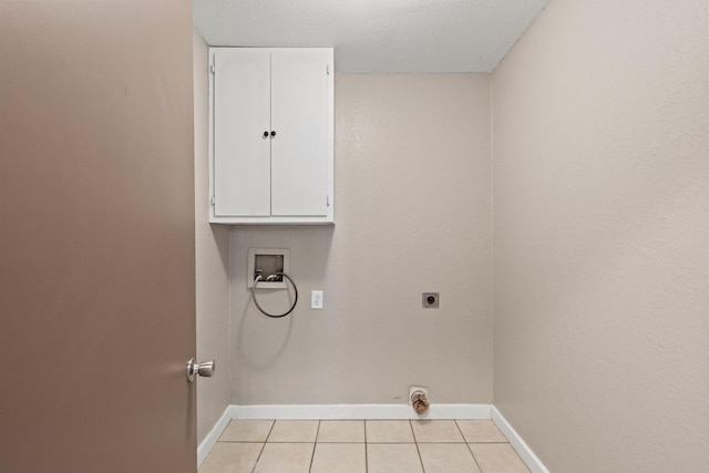 laundry area featuring light tile patterned floors, hookup for a washing machine, baseboards, electric dryer hookup, and cabinet space