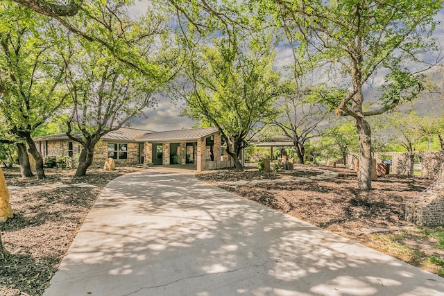 surrounding community featuring a carport and concrete driveway