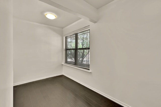 empty room featuring dark wood finished floors and baseboards