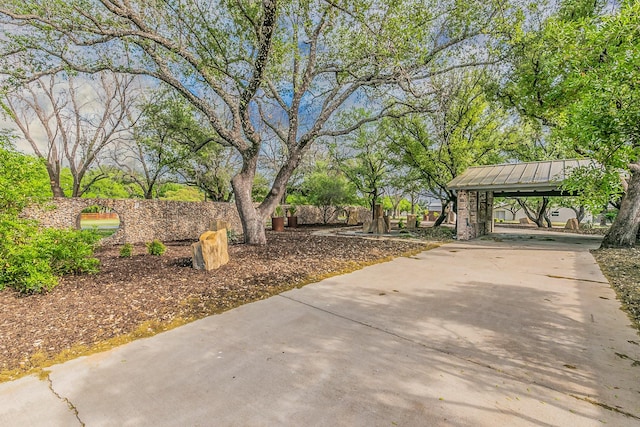 view of property's community featuring a carport and concrete driveway