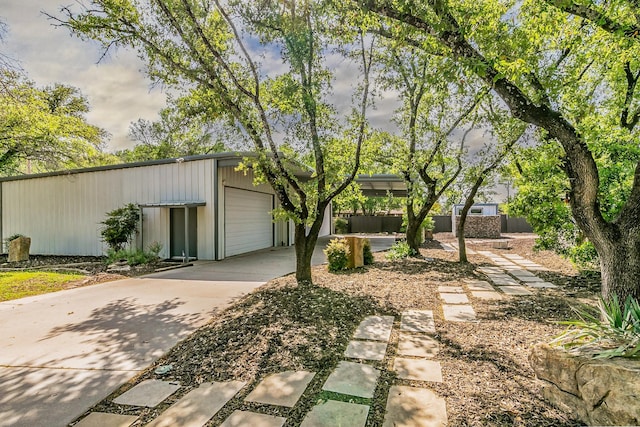 view of front of home with an outdoor structure and concrete driveway