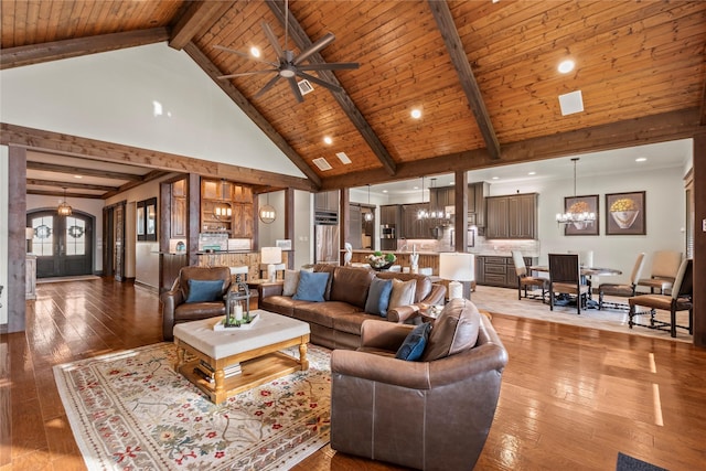 living area featuring wooden ceiling, light wood-style floors, beam ceiling, high vaulted ceiling, and ceiling fan with notable chandelier