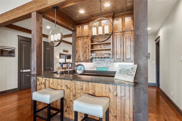 kitchen with baseboards, tasteful backsplash, open shelves, and dark wood-style flooring