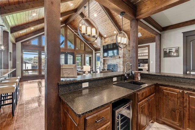 bar featuring beamed ceiling, beverage cooler, wood ceiling, and a sink