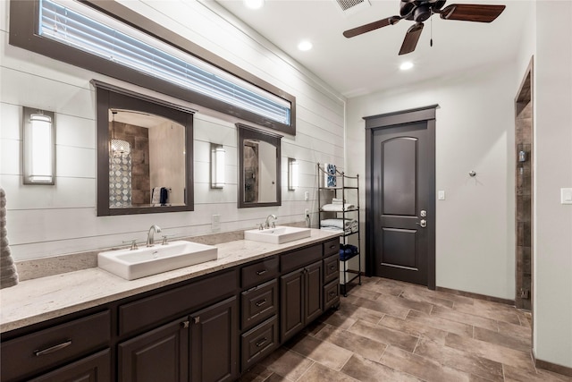 full bathroom featuring double vanity, a sink, recessed lighting, and ceiling fan