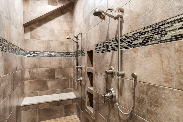 interior details featuring a tile shower