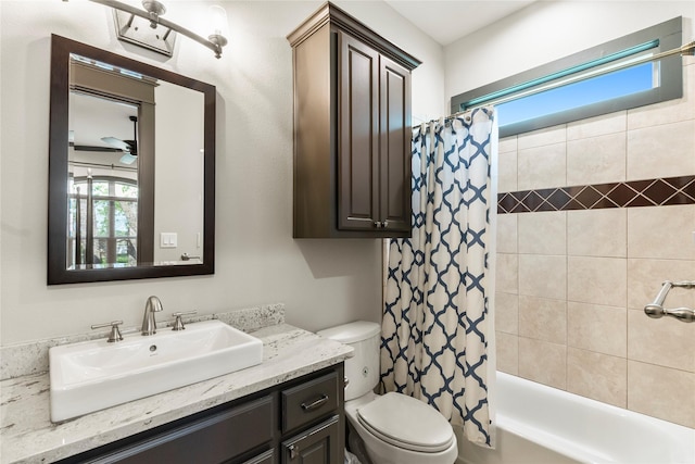full bathroom featuring shower / bath combo with shower curtain, toilet, and vanity