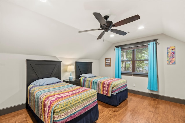 bedroom with vaulted ceiling, a ceiling fan, baseboards, and wood finished floors