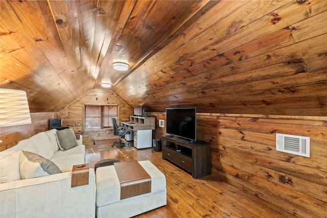 living area with wooden walls, vaulted ceiling, visible vents, wooden ceiling, and hardwood / wood-style flooring
