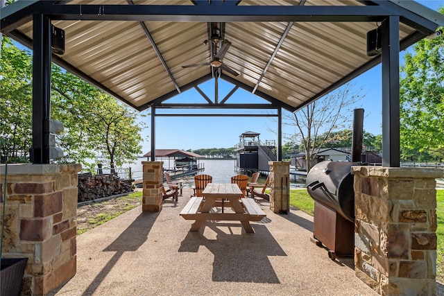 view of patio featuring a grill, a water view, and a gazebo