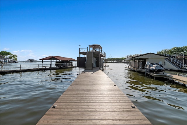 view of dock with boat lift and a water view