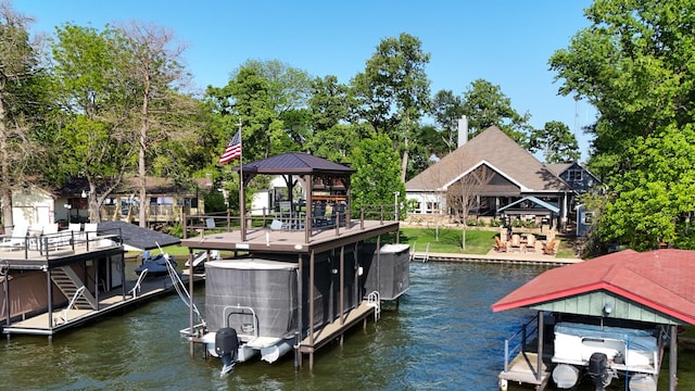 view of dock with a gazebo, boat lift, and a water view