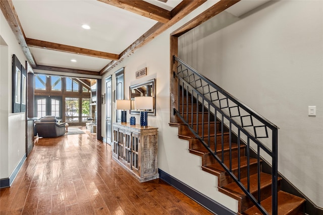 stairway with recessed lighting, baseboards, beam ceiling, and hardwood / wood-style floors