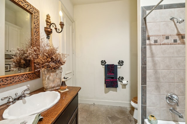 bathroom with vanity, baseboards, toilet, and shower / washtub combination