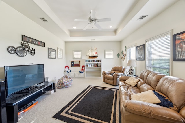 living room featuring ceiling fan, visible vents, recessed lighting, a tray ceiling, and carpet flooring