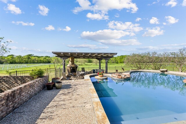 view of swimming pool with an outdoor fireplace, a fenced in pool, a fenced backyard, and a patio area