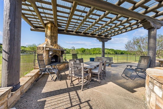 view of patio with fence, a pergola, outdoor dining area, and an outdoor stone fireplace