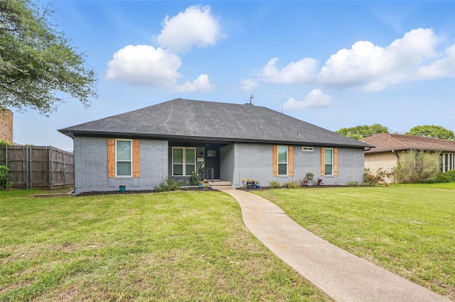 ranch-style home featuring fence, a front lawn, brick siding, and roof with shingles