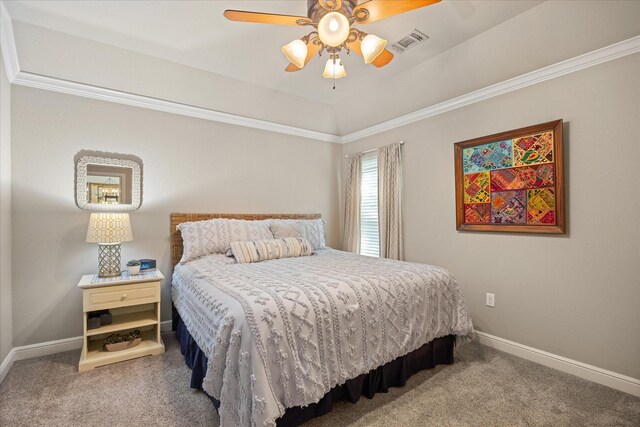 carpeted bedroom featuring visible vents, a ceiling fan, baseboards, and ornamental molding