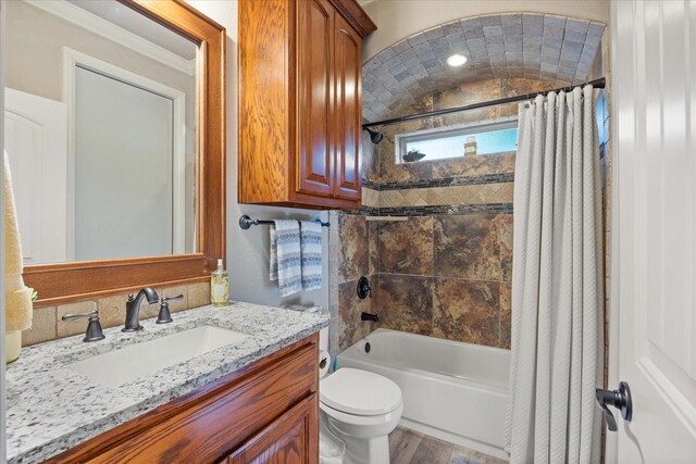 full bath with vanity, toilet, wood finished floors, and shower / tub combo