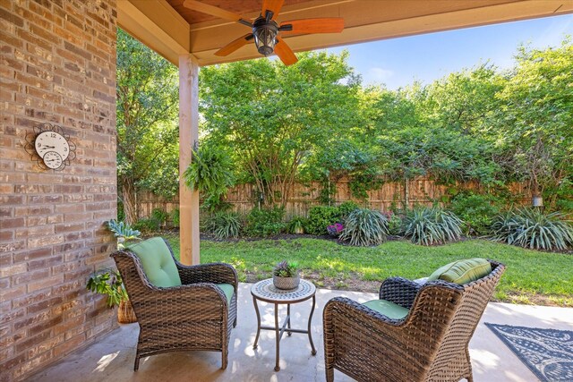 view of patio / terrace with a ceiling fan and fence