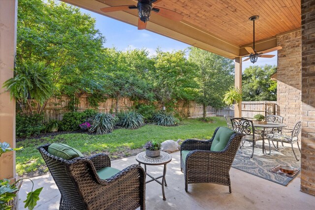 view of patio with a fenced backyard, ceiling fan, and outdoor dining space