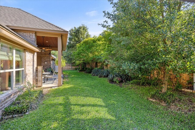 view of yard featuring fence and a patio