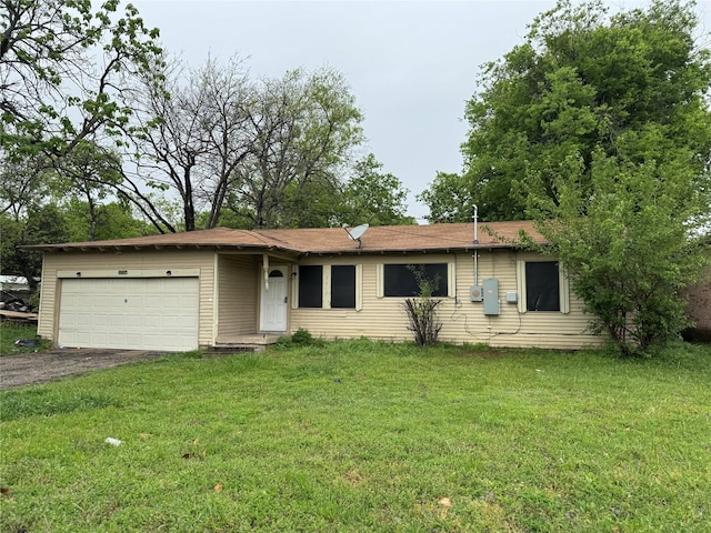 ranch-style home featuring an attached garage, driveway, and a front yard