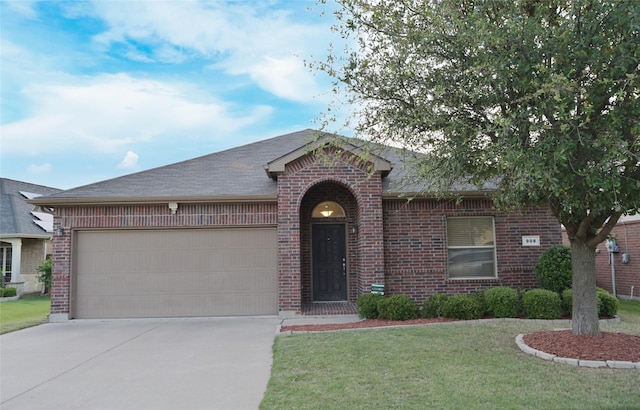 single story home with concrete driveway, an attached garage, brick siding, and a front lawn