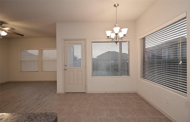 interior space featuring ceiling fan with notable chandelier