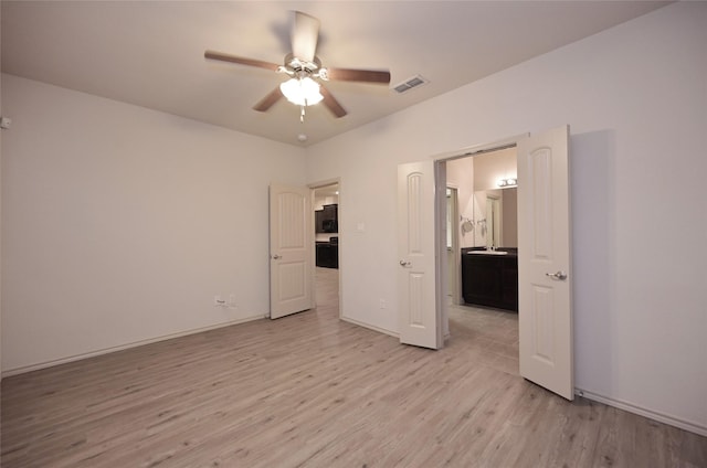 unfurnished bedroom with ceiling fan, baseboards, visible vents, and light wood-type flooring