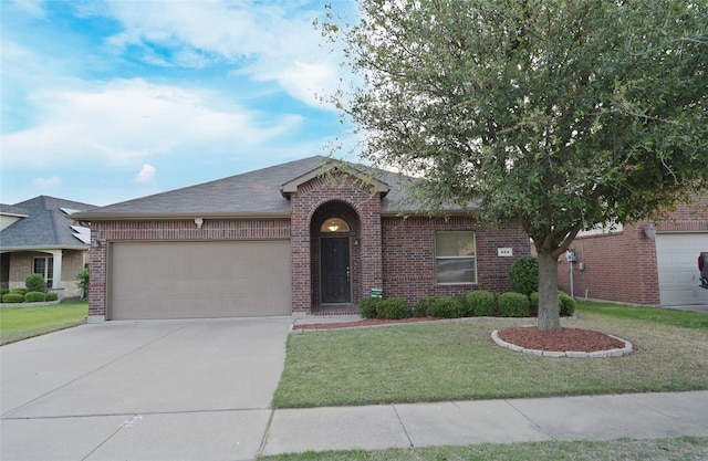 ranch-style home featuring a shingled roof, driveway, brick siding, a front yard, and a garage