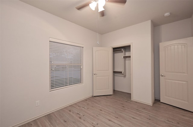 unfurnished bedroom featuring wood finished floors, baseboards, and ceiling fan